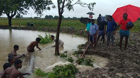 ஏரி உடைப்பைச் சரிசெய்த விவசாயிகள்.