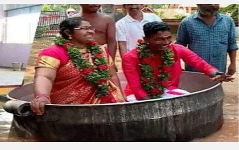 சமையல் பாத்திரத்தைத் தோணியாக மாற்றி அமர்ந்து கோயிலில் திருமணம் செய்த ஆகாஷ், ஐஸ்வர்யா ஜோடி | படம்: ஏஎன்ஐ.