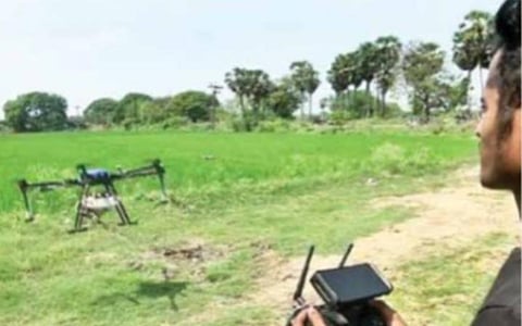 புதுச்சேரி அருகேயுள்ள கொடாத்தூர் கிராமத்தில் ‘ட்ரோன்’ மூலம் நெற்பயிருக்கு மருந்து தெளிக்கப்படுகிறது.