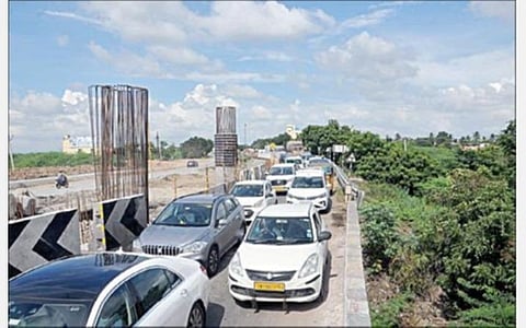 கடும் போக்குவரத்து நெரிசலால், விழுப்புரம் ஜானகிபுரம் மேம்பாலம் பகுதியில் நீண்ட வரிசையில் அணிவகுத்து நிற்கும் வாகனங்கள்.