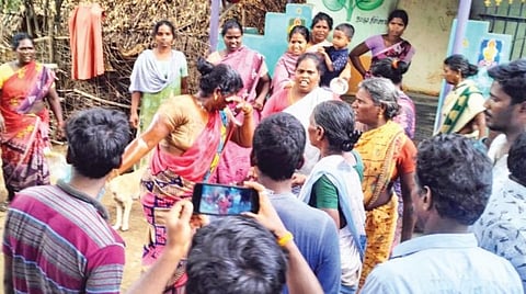 கரிவெட்டி கிராமத்தில் அளவீடு செய்ய எதிர்ப்பு தெரிவித்து தீ குளிக்க முயன்ற பெண்.