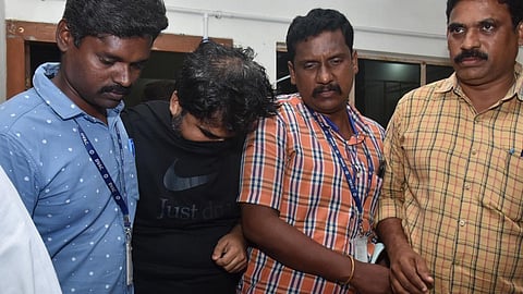 கைது செய்யபபட்ட அமலாக்க துறை அதிகாரி (கருப்பு சட்டை அணிந்து இருப்பவர்)