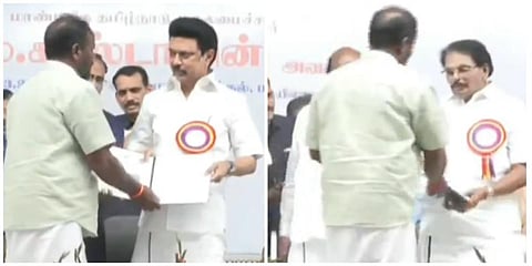 முதல்வரிடம் இழப்பீட்டுத் தொகைக்கான காசோலையைப் பெறும் மீனவர் ரமேஷ் அதனை அமைச்சர் கே.கே.எஸ்.எஸ்.ஆர் ராமசந்திரனிடம் திரும்பக் கொடுக்கிறார்