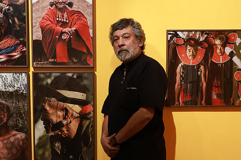 Pablo Bartholomew along with photographs clicked by him displayed at the exhibition 
