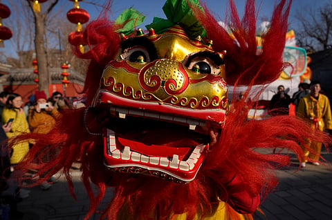 An artist performs a lion dance to cheer the visitors at the Dongyue Temple on the first day of the Chinese Lunar New Year in Beijing on Wednesday, Jan. 29, 2025