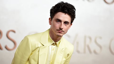 Timothée Chalamet in a custom butter-yellow leather suit by Givenchy