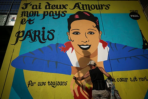 Artist Franck Duval, aka FKDL, works on a mural of U.S.-French entertainer and civil rights activist Josephine Baker in Paris, Saturday, July 19, 2025
