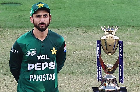 Pakistan’s captain Salman Agha stands next to the trophy during the toss before the start of the Asia Cup 2025 
