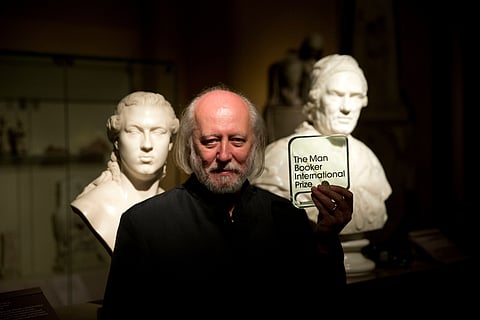 Hungary's Laszlo Krasznahorkai poses for photographers in London, Tuesday, May 19, 2015