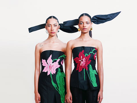 The collection explores asymmetry and deconstruction through constructed skirts, exaggerated sleeves and sculptural tube dresses