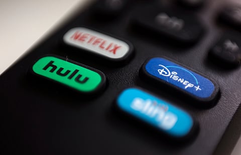 The logos for streaming services Netflix, Hulu, Disney Plus and Sling TV are pictured on a remote control on Aug. 13, 2020, in Portland, Ore
