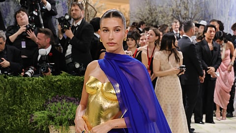 Hailey Bieber stuns in 24-karat gold bodice and flowing blue Saint Laurent gown at the 2026 Met Gala
