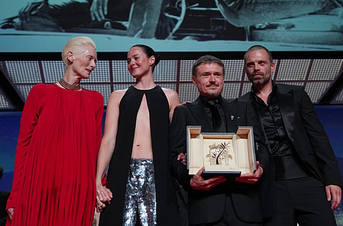 Left to right: Tilda Swinton poses with Renate Reinsve, Cristian Mungiu — winner of the Palme d'Or for Fjord — and Sebastian Stan, during the awards ceremony at the 79th Cannes international film festival, in southern France, on Saturday