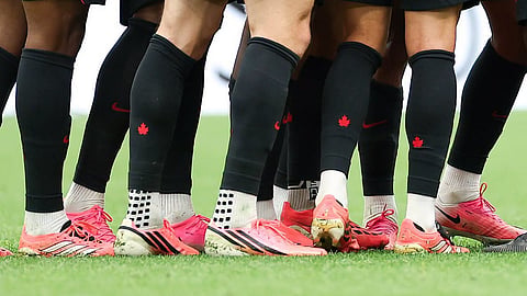 Why are most footballers wearing pink boots at the FIFA World Cup?  