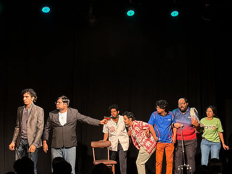 Cast members rehearse a dramatic scene on stage during a Theatre Marina production.
