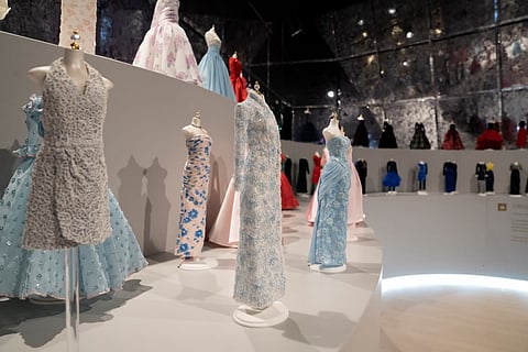 Authentic Princess Diana evening gown displayed in a lit glass showcase at the Las Vegas exhibition.