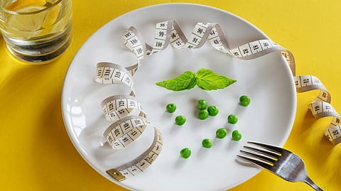 a white plate topped with peas and measuring tape