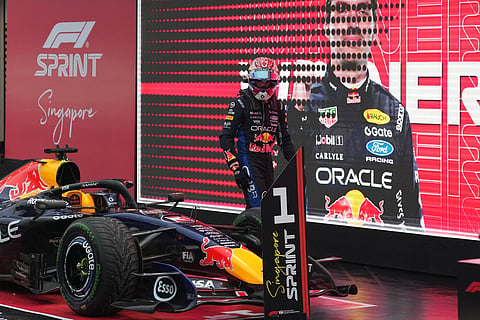 Max Verstappen leading the 2026 Singapore Grand Prix Sprint race on intermediate tyres at Marina Bay.