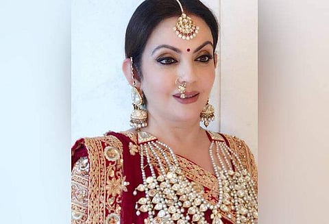 Nita Ambani in a maroon Abu Jani Sandeep Khosla saree