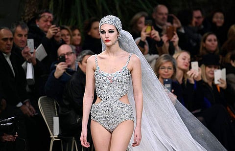 A model wears a bridal swimsuit creation for the Chanel Spring/Summer 2019 Haute Couture fashion collection.