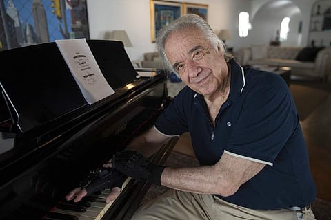 Brazilian pianist Joao Carlos Martins wearing bionic gloves (AP Photo/Andre Penner)