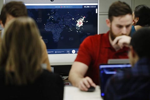Workers at HealthMap (AP Photo/Steven Senne)