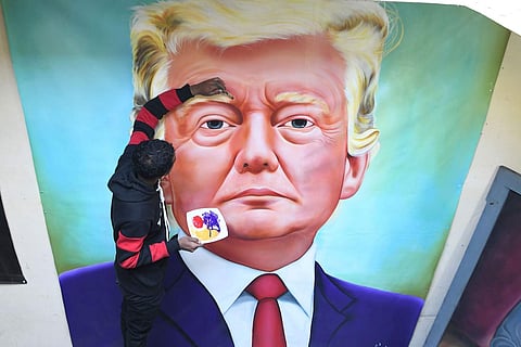 Amritsar, Punjab: Painter Jagjot Singh Rubal gives final touches to a painting of Donald Trump, days before the US President and his wife Melania are scheduled to arrive in India. (AFP/Narinder Nanu)