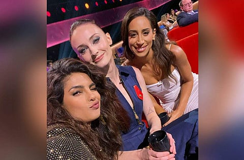 In the picture, Priyanka is seen taking a selfie while posing with Danielle and Sophie, their father-in-law is seen seated at a distance and focused on what's happening on stage.