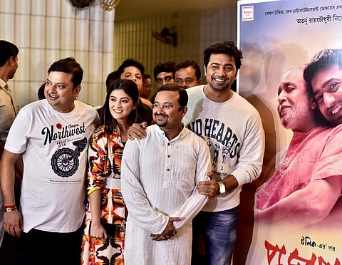 The cast and crew pose for a snap