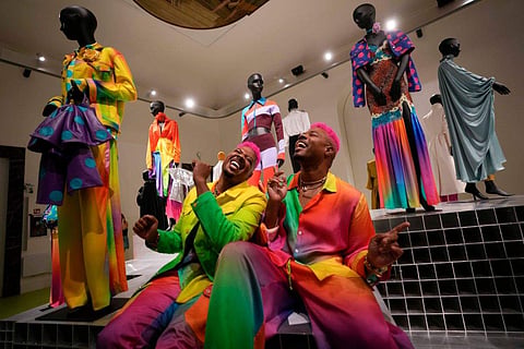 From left, designers Glen and Bruce Proctor laugh as they pose for portraits in front of their creations at the fashion hub, during the women's Spring Summer 2024 fashion week, in Milan