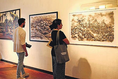 Visitors at  PR Sugathan's exhibition ‘Out of the Black’ in Kochi
