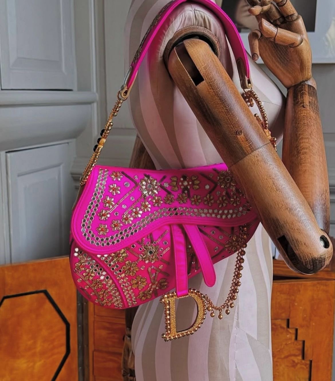 This rare Dior bag in hot pink with mirror work and nath detailing