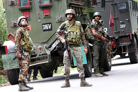 Army personnel stand guard at the encounter site where a jawan was killed in a gunfight with terrorists, in Kulgam on Saturday.