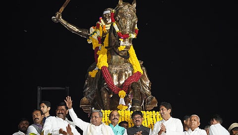 CM Siddaramaiah greets the gathering after paying tributes to Rani Chennamma at the valedictory function of Kittur Utsav, in Kittur, Belagavi, on Friday.