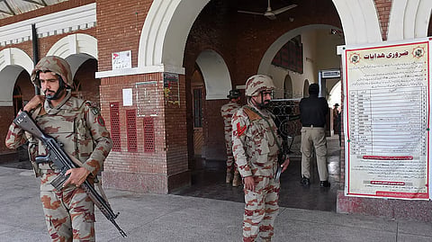 Paramilitary soldiers stand guard at a railway station in the Sibi district of southwestern Balochistan province on March 12, 2025, during a security operation against militants a day after they hijacked a passenger train.