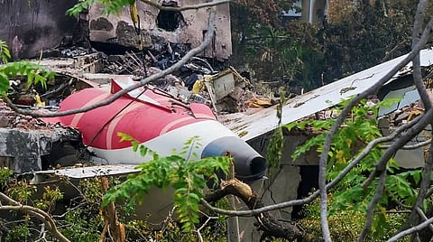 A crane removing aeroplane's tail from the wreckage after the June 12 Air India flight 171 crash