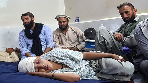An injured Afghan boy (bottom) receives treatment at a hospital 