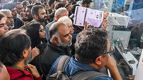Passengers crowd in front of a counter following cancellation of IndiGo flights in Bengaluru, on Friday.
