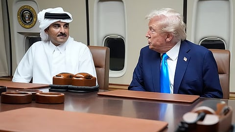 President Donald Trump, right, meets with Emir of Qatar Sheikh Tamim bin Hamad al-Thani aboard Air Force One at Al Udeid Air Base in Doha, Qatar