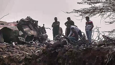 A team of forensic experts investigates the site of the plane crash