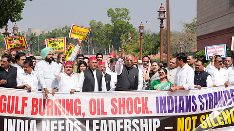 opposition leaders stage a protest over the West Asia crisis with posters and banners reading, Gulf burning, oil shock.