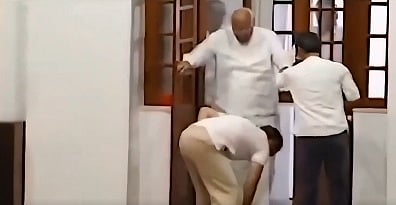 Rahul Gandhi helps to put shoe to Mallikarjun Kharge 