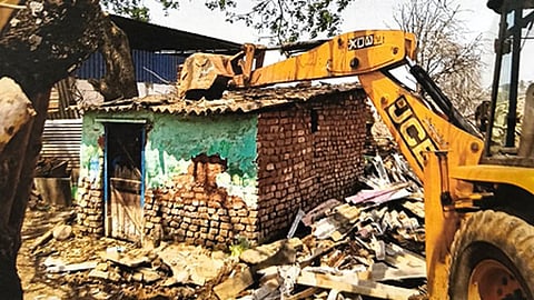 Local authorities demolishing the houses constructed on the lake area illegally in Jagalur of Davanagere district