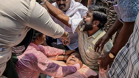 TMC MP Kalyan Banerjee receives assistance after he was allegedly attacked.