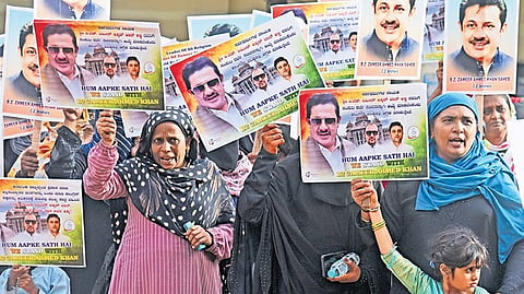 Supporters of former minister Zameer Ahmed Khan stage a protest demanding DCM post for him at Freedom Park in Bengaluru on Friday.