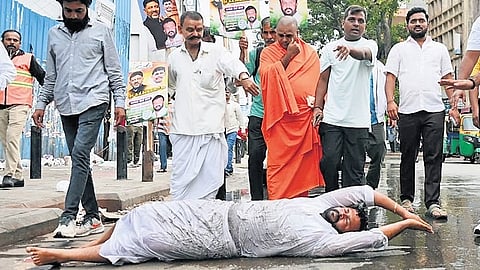 A supporter of CM DK Shivakumar performs urulu seve from Anand Rao Circle to Annamma Devi Temple in Bengaluru