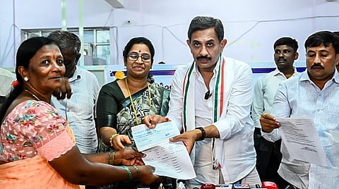 Distributing checks to farmers.