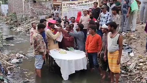 BJP Councillor In Agra Cuts Birthday Cake Standing In A Drain