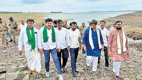 BJP leaders inspect the KRS reservoir built across the Cauvery river in Mandya district on Saturday