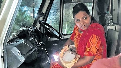 A health department staffer takes possession of an infant abandoned in Gavaturu village on Sunday night.